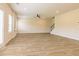 Spacious living room with hardwood floors, large windows, and staircase at 1613 Fuma Leaf Way, Mcdonough, GA 30253