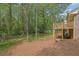 Exterior view of backyard with brick home and wooden deck at 3512 Hidden Acres Drive, Atlanta, GA 30340