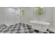 Bathroom featuring a modern soaking tub, walk-in shower, and checkered floors at 3512 Hidden Acres Drive, Atlanta, GA 30340