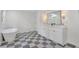 Bathroom featuring a double vanity, walk-in shower, modern soaking tub, and checkered floors at 3512 Hidden Acres Drive, Atlanta, GA 30340