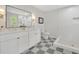 Bathroom featuring a double vanity, walk-in shower, checkered floors, and natural light at 3512 Hidden Acres Drive, Atlanta, GA 30340