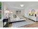 Bright bedroom featuring a cozy bed, natural light, and stylish decor at 3512 Hidden Acres Drive, Atlanta, GA 30340
