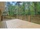 Wide angle, full shot on this wooden deck with wood railing overlooking lush greenery at 3512 Hidden Acres Drive, Atlanta, GA 30340