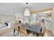 Open-concept dining area boasts modern light fixture and access to a living room and kitchen for easy entertaining at 3512 Hidden Acres Drive, Atlanta, GA 30340