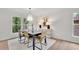 Elegant dining room with modern lighting, hardwood floors, and large windows at 3512 Hidden Acres Drive, Atlanta, GA 30340