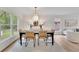 Bright dining room featuring stylish furnishings, hardwood floors, and a view of the yard at 3512 Hidden Acres Drive, Atlanta, GA 30340