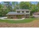 Charming two-story home features a brick facade, gray roof, and a well-manicured lawn at 3512 Hidden Acres Drive, Atlanta, GA 30340