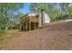 Back exterior view with wooden deck and chimney at 3512 Hidden Acres Drive, Atlanta, GA 30340