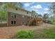 Exterior rear view of home with brick facade, large windows, a walk-out basement, and a wooden deck at 3512 Hidden Acres Drive, Atlanta, GA 30340