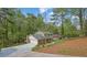 Two-story home with a long driveway and a two-car garage surrounded by mature trees at 3512 Hidden Acres Drive, Atlanta, GA 30340