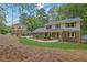Beautiful two-story home with a brick and siding exterior surrounded by lush greenery at 3512 Hidden Acres Drive, Atlanta, GA 30340
