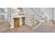 Inviting foyer with brick flooring, a staircase, and a view into the modern kitchen at 3512 Hidden Acres Drive, Atlanta, GA 30340