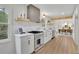 Well-lit modern kitchen with stainless steel appliances, sleek cabinetry, and wood accents overlooking the dining area at 3512 Hidden Acres Drive, Atlanta, GA 30340