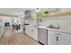 Bright kitchen features stainless steel appliances, white cabinetry, and a breakfast nook with backyard views at 3512 Hidden Acres Drive, Atlanta, GA 30340