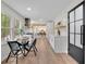 Bright kitchen featuring a breakfast nook with backyard views leading to dining area and a modern entrance door at 3512 Hidden Acres Drive, Atlanta, GA 30340