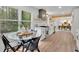 Bright kitchen featuring a cozy breakfast nook and backyard views with stainless steel appliances and white cabinets at 3512 Hidden Acres Drive, Atlanta, GA 30340