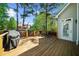 A spacious, wooden back deck perfect for outdoor dining and relaxation with a grill and seating set at 6252 Fernstone Trl, Acworth, GA 30101