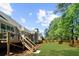 Backyard shows a large lawn and a deck with stairs connecting the house to the yard and fence at 6252 Fernstone Trl, Acworth, GA 30101