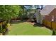 A spacious backyard with a well-kept lawn, a wooden fence, and a deck, perfect for outdoor activities at 6252 Fernstone Trl, Acworth, GA 30101