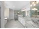 Bright bathroom with granite countertop, double sinks, glass shower, and freestanding bathtub at 6252 Fernstone Trl, Acworth, GA 30101