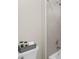 Bathroom featuring a gray-tiled shower, toilet and grey accent pieces at 6252 Fernstone Trl, Acworth, GA 30101
