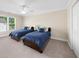 Bedroom with two beds, a ceiling fan, and a large window overlooking the yard at 6252 Fernstone Trl, Acworth, GA 30101