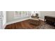Bedroom with reading chair and plantation shutters with rich hardwood floors at 6252 Fernstone Trl, Acworth, GA 30101