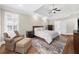 Relaxing bedroom with sitting area, plantation shutters, and rich hardwood floors at 6252 Fernstone Trl, Acworth, GA 30101