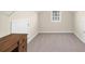 Empty room with a window, carpeted floors, white walls and closet space with shelves at 6252 Fernstone Trl, Acworth, GA 30101