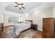 Bedroom features large window with shutters and rich hardwood floors at 6252 Fernstone Trl, Acworth, GA 30101