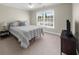 Bedroom featuring a queen-sized bed, neutral decor, and natural light from a window at 6252 Fernstone Trl, Acworth, GA 30101