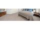 Carpeted bedroom with a neutral color scheme and a view to an adjacent room at 6252 Fernstone Trl, Acworth, GA 30101