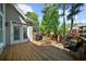 Spacious wooden deck with an outdoor grill, seating, and views of the backyard at 6252 Fernstone Trl, Acworth, GA 30101