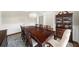 Dining room with hardwood floors features large dark wood table and display cabinet at 6252 Fernstone Trl, Acworth, GA 30101