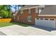 A two car garage door is featured on this beautiful red brick home at 6252 Fernstone Trl, Acworth, GA 30101