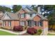 Charming brick home featuring manicured landscaping, a stone chimney and a welcoming entrance at 6252 Fernstone Trl, Acworth, GA 30101
