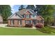 Lovely brick home with well-kept lawn, featuring classic architecture and dark shutters at 6252 Fernstone Trl, Acworth, GA 30101