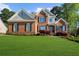 Beautiful brick two-story home with a well-manicured lawn and charming curb appeal at 6252 Fernstone Trl, Acworth, GA 30101