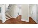 Hallway with hardwood flooring leading to stairs and bathroom at 6252 Fernstone Trl, Acworth, GA 30101