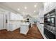 Open-concept kitchen featuring stainless appliances and a kitchen island at 6252 Fernstone Trl, Acworth, GA 30101