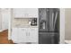 Well-lit kitchen with a stainless steel refrigerator and granite countertops at 6252 Fernstone Trl, Acworth, GA 30101