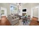 Bright living room featuring a fireplace, high ceilings, and large windows providing natural light at 6252 Fernstone Trl, Acworth, GA 30101