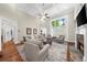 Bright living room featuring a fireplace, high ceilings, a ceiling fan, and large windows at 6252 Fernstone Trl, Acworth, GA 30101