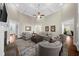 Bright living room featuring a ceiling fan, fireplace, and hardwood floors at 6252 Fernstone Trl, Acworth, GA 30101