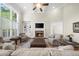 Living room with high ceilings, stone fireplace, built in shelves, and large windows at 6252 Fernstone Trl, Acworth, GA 30101