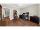 A well-lit home office featuring hardwood floors, built-in bookshelves, and traditional furnishings at 6252 Fernstone Trl, Acworth, GA 30101