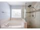 Beautifully remodeled bathroom with shower and bathtub combo with tiled walls and pebble shower floor at 2361 Maplewood Ct # 25, Atlanta, GA 30339