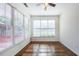 Bright, empty room with hardwood floors, large windows, and a ceiling fan, ready for personal touches at 2361 Maplewood Ct # 25, Atlanta, GA 30339