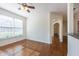 Bright empty room featuring hardwood floors and large window, flowing into hallway at 2361 Maplewood Ct # 25, Atlanta, GA 30339