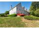 Expansive backyard featuring a red deck, lush green lawn, and mature landscaping at 2361 Maplewood Ct # 25, Atlanta, GA 30339